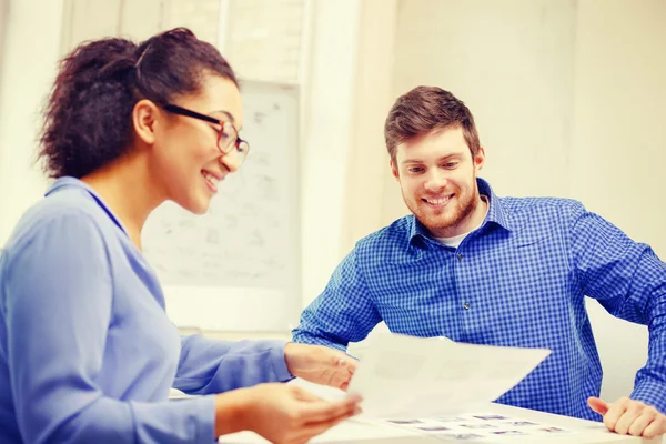 Squadra sorridente con carta in ufficio — Foto Stock