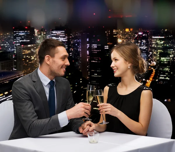 Couple with glasses of champagne at restaurant — Stock Photo, Image