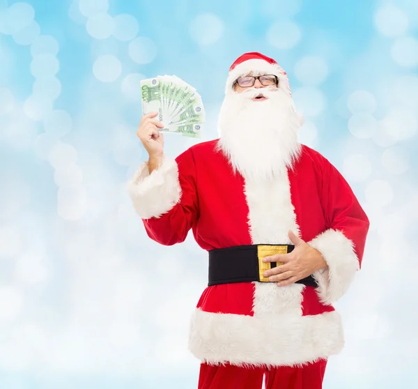 在服装的圣诞老人与欧元钱的男人 — 图库照片