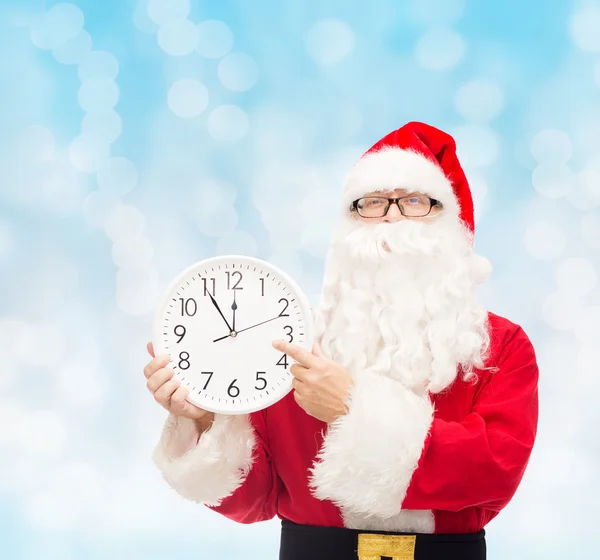 Man in costume of santa claus with clock — Stock Photo, Image