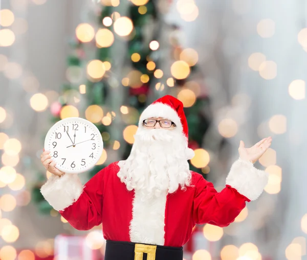 Man in costume of santa claus with clock — Stock Photo, Image