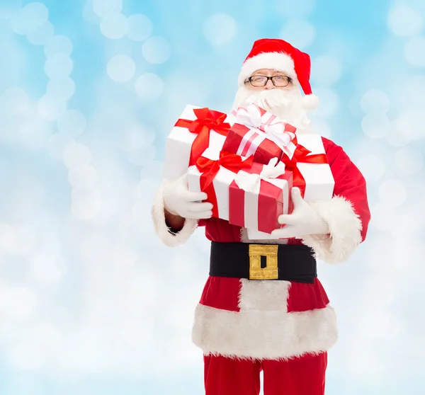 Man in costume of santa claus with gift boxes — Stock Photo, Image