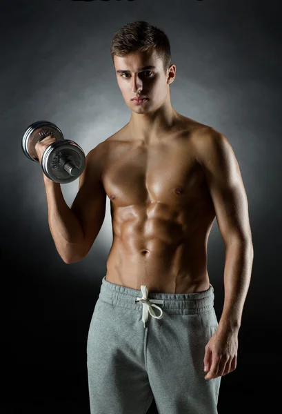 Young man with dumbbell — Stock Photo, Image