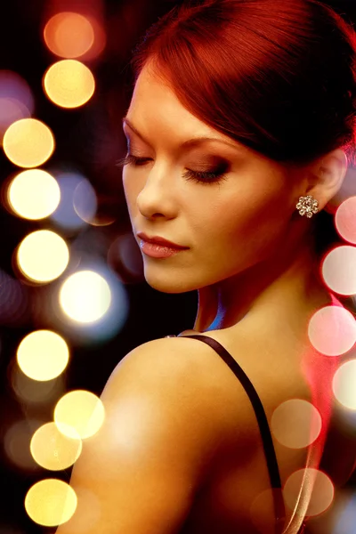 Woman in evening dress wearing diamond earrings — Stock Photo, Image