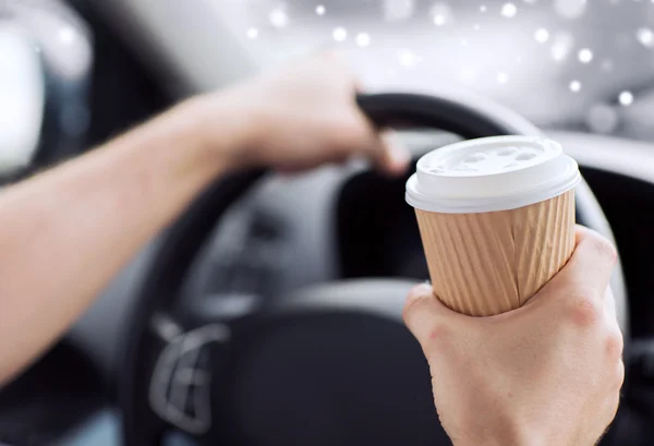 Close up of man drinking coffee while driving car — Stock Photo, Image