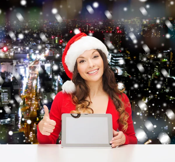 Mujer sonriente en sombrero de santa con regalo y tableta pc — Foto de Stock