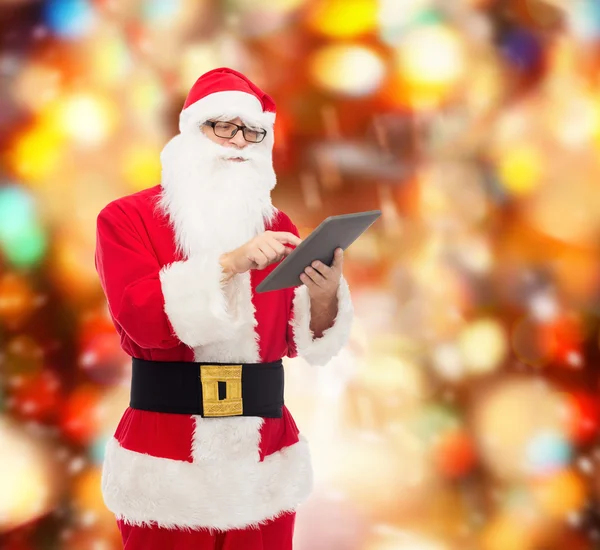 Man in costume of santa claus with tablet pc — Stock Photo, Image