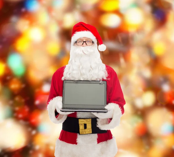 Man in costume of santa claus with laptop — Stock Photo, Image