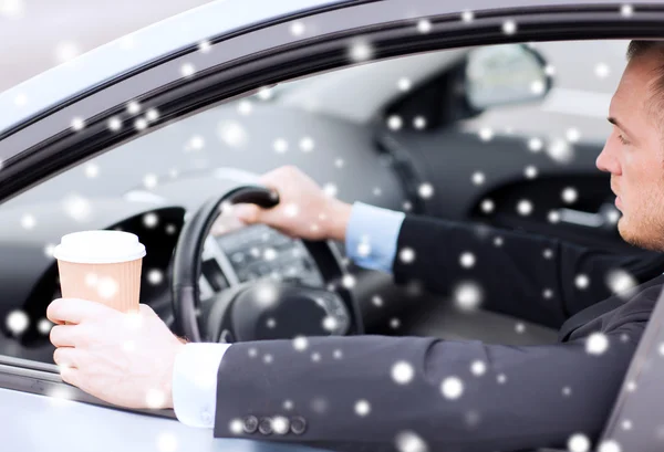 Close up of man drinking coffee while driving car — Stock Photo, Image