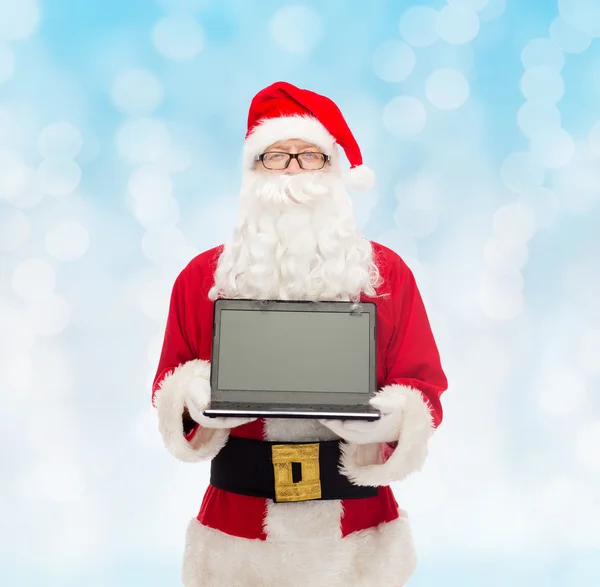 Mann im Weihnachtsmannkostüm mit Laptop — Stockfoto