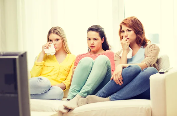 Three sad teenage girl watching tv at home — Stock Photo, Image