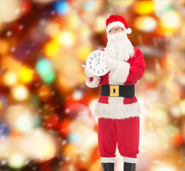 Man in costume of santa claus with clock — Stock Photo, Image