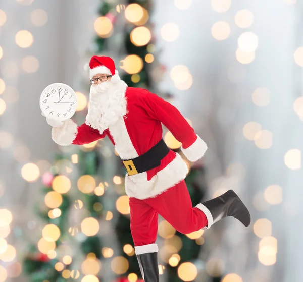 Man in costume of santa claus with clock — Stock Photo, Image