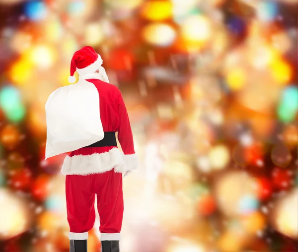 Homme en costume de Père Noël claus avec sac — Photo