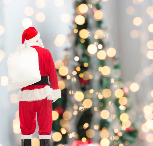 Man in costume of santa claus with bag — Stock Photo, Image