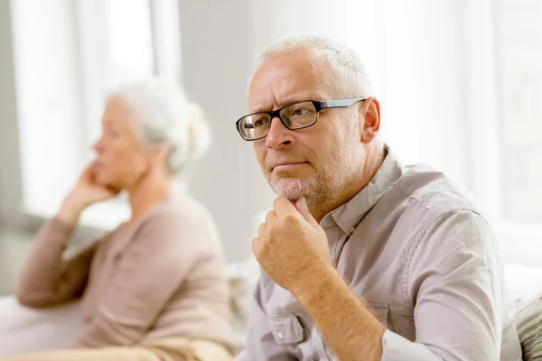 Senior couple sitting on sofa at home — Stock Photo, Image