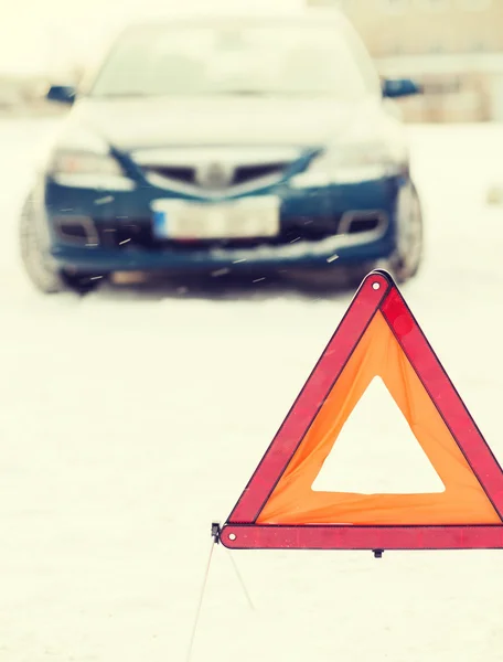 Closeup of warning triangle and car — Stok fotoğraf