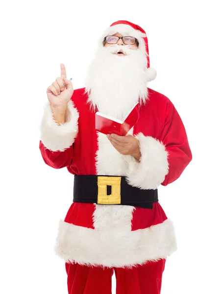 Mann im Weihnachtsmannkostüm mit Notizblock — Stockfoto