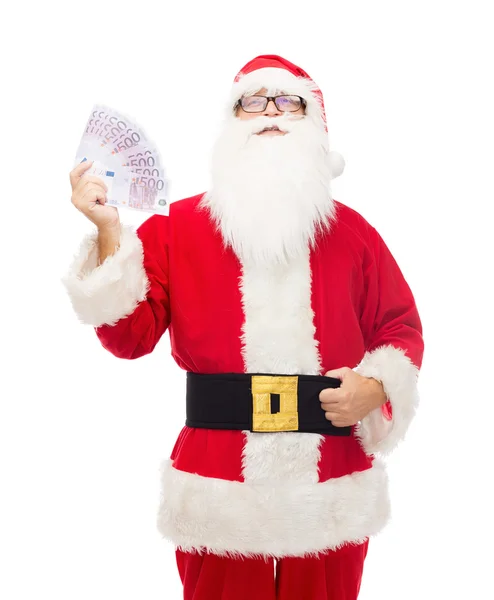 Hombre disfrazado de santa claus con dinero en euros — Foto de Stock