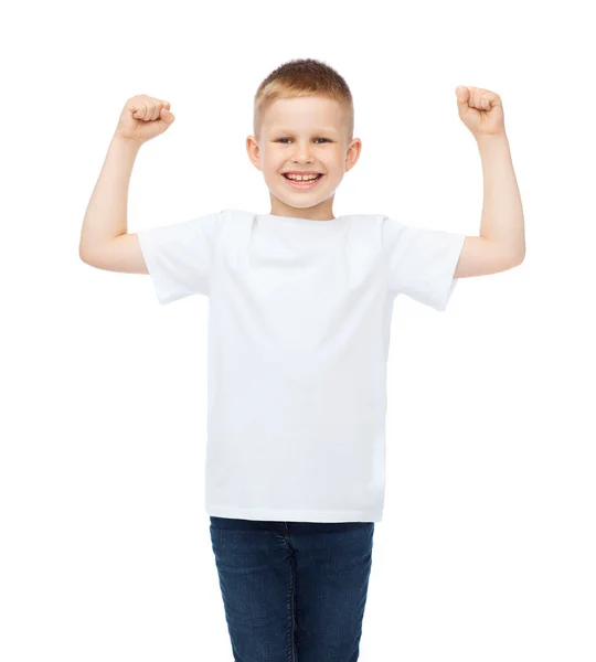 Little boy in blank white t-shirt showing muscles — Stock Photo, Image