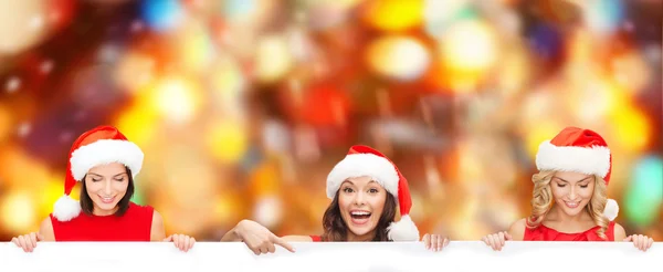 Santa kalap segítő üres fehér tábla a nők — Stock Fotó