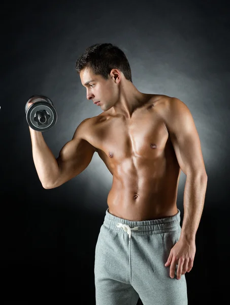 Young man with dumbbell — Stock Photo, Image