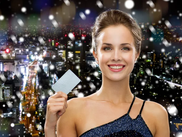 Femme souriante en robe de soirée tenant carte de crédit — Photo