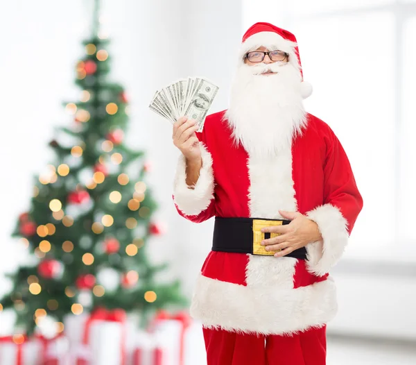 Mann im Kostüm des Weihnachtsmannes mit Dollargeld — Stockfoto