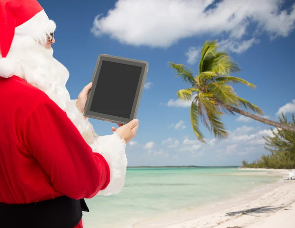 Man in kostuum van de kerstman met tablet pc — Stockfoto