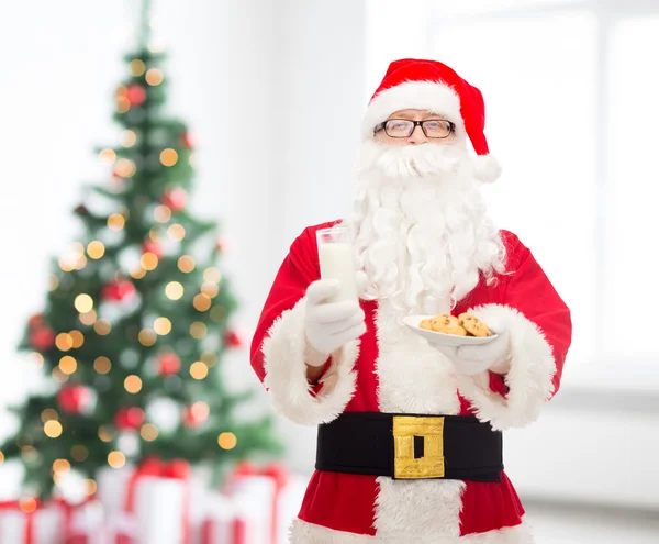 Santa claus with glass of milk and cookies — Stock Photo, Image