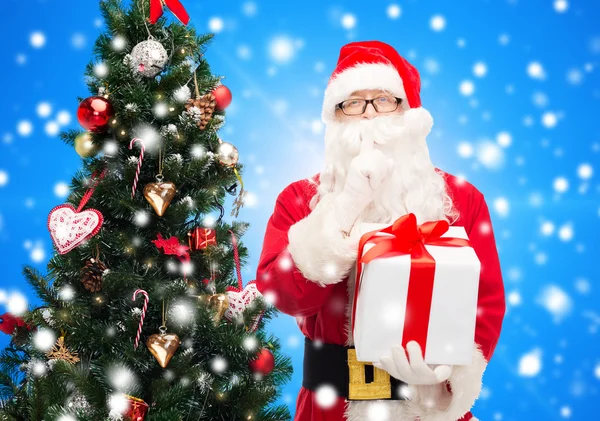 Man in costume of santa claus with gift box — Stock Photo, Image