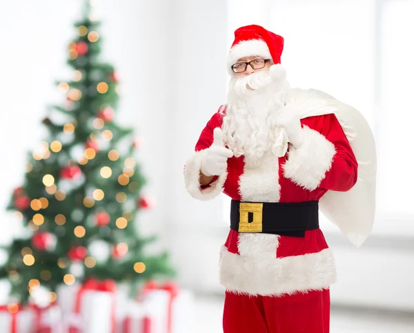 Man in costume of santa claus with bag — Stock Photo, Image