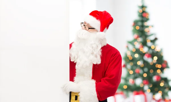 Man in costume of santa claus with billboard — Stock Photo, Image