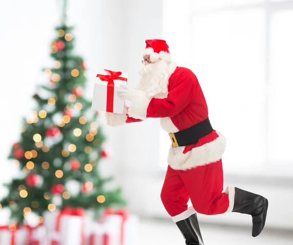 Man in costume of santa claus with gift box — Stock Photo, Image