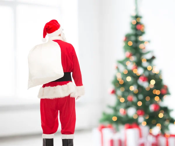 Man in costume of santa claus with bag — Stock Photo, Image