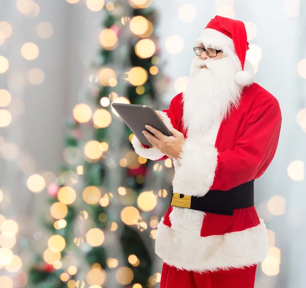 Man in costume of santa claus with tablet pc — Stock Photo, Image