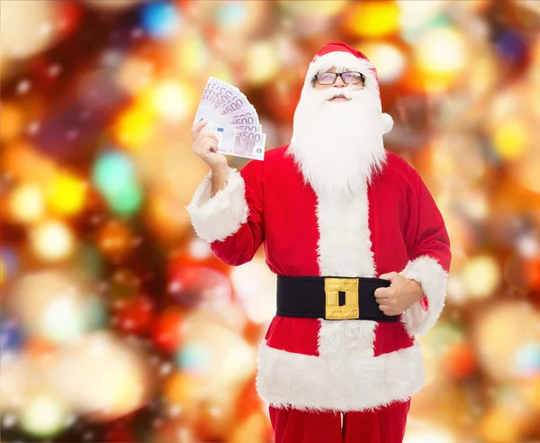 Mannen i kostym jultomten med euron pengar — Stockfoto