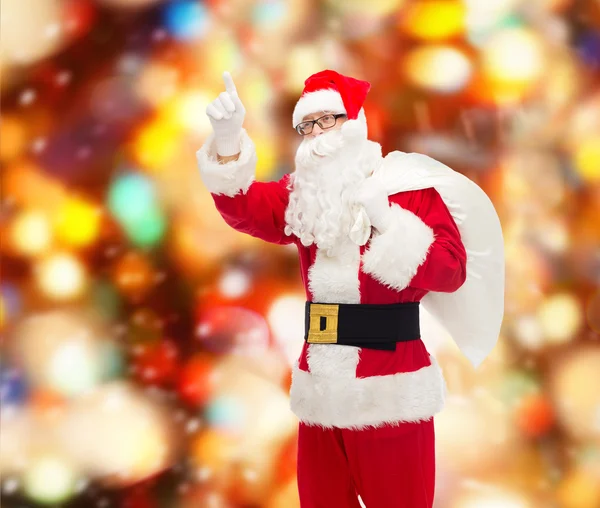 Homme en costume de Père Noël claus avec sac — Photo