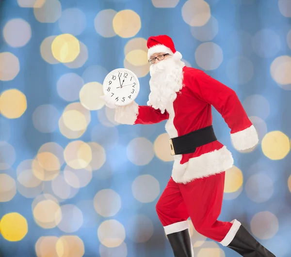 Man in costume of santa claus with clock — Stock Photo, Image