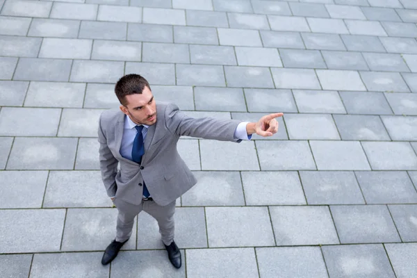 Young smiling businessman outdoors from top — Stock Photo, Image