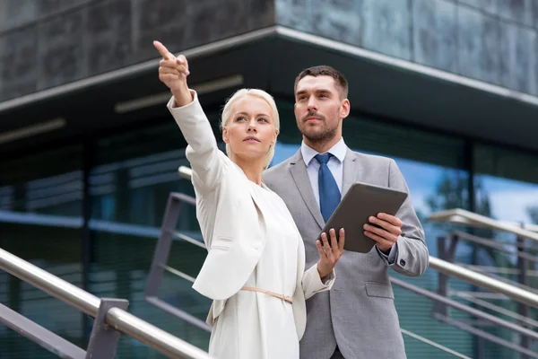 Serious businessmen with tablet pc outdoors — Stock Photo, Image