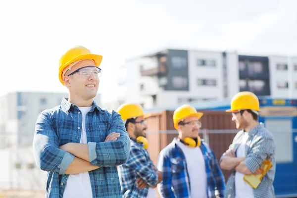 Ομάδα των χαμογελαστά οικοδόμων στο hardhats υπαίθρια — Φωτογραφία Αρχείου