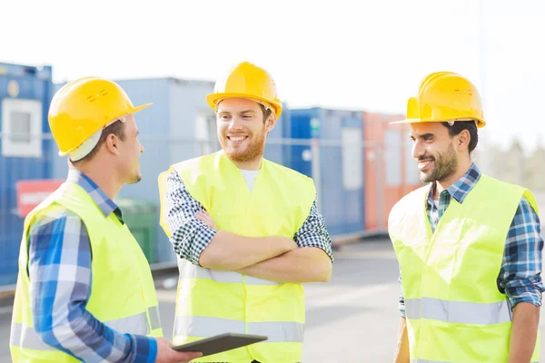 Smiling builders in hardhats with tablet pc — Stock Photo, Image