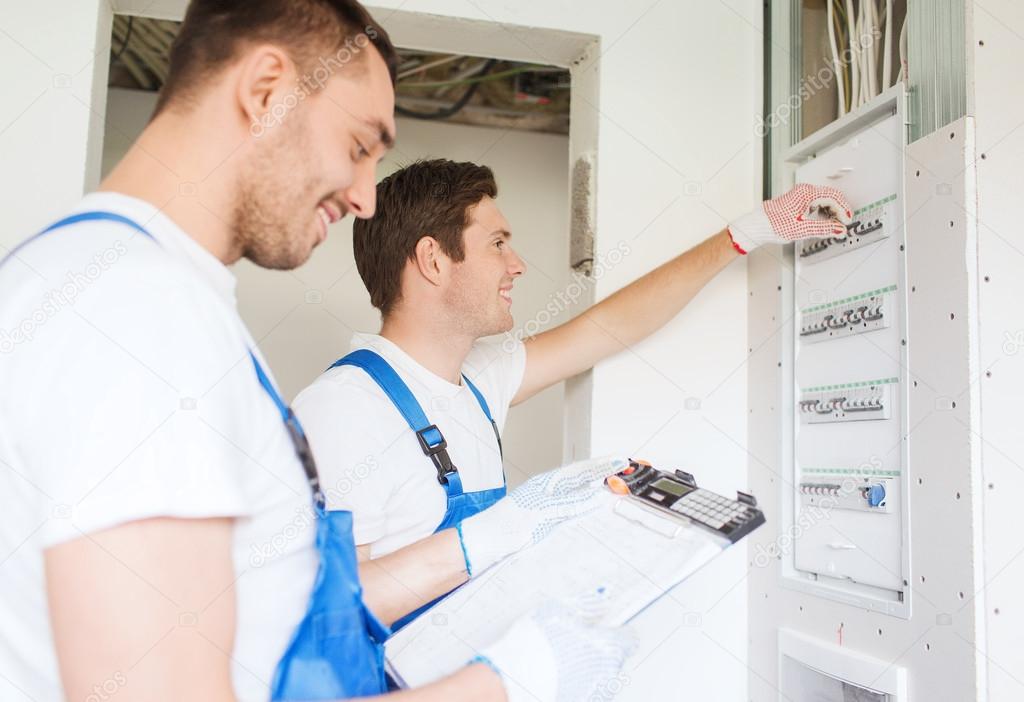 Builders with clipboard and electrical panel — Stock Photo © Syda_Productions 56758497