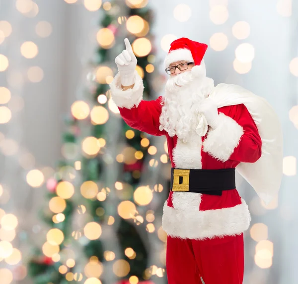 Man in costume of santa claus with bag — Stock Photo, Image