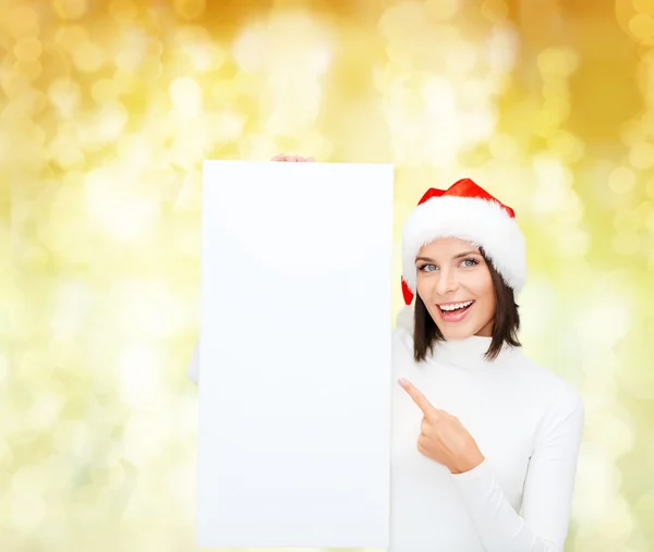 Uśmiechnięta młoda kobieta w santa hat z biały deska — Zdjęcie stockowe