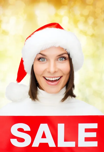Smiling woman in santa helper hat with sale sign — Stock Photo, Image