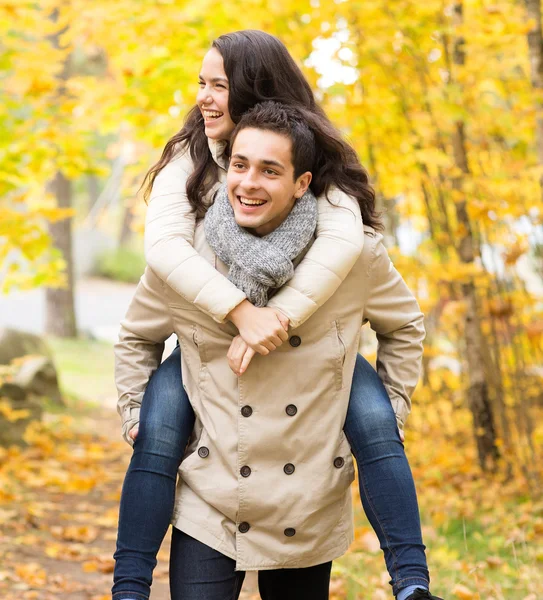 Sonriente pareja divirtiéndose en el parque de otoño —  Fotos de Stock