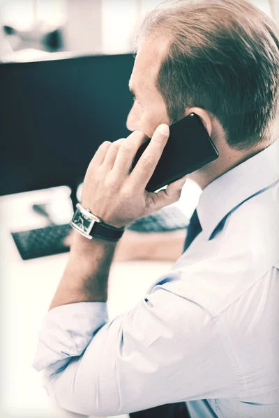 Businessman with smartphone in office — Stock Photo, Image