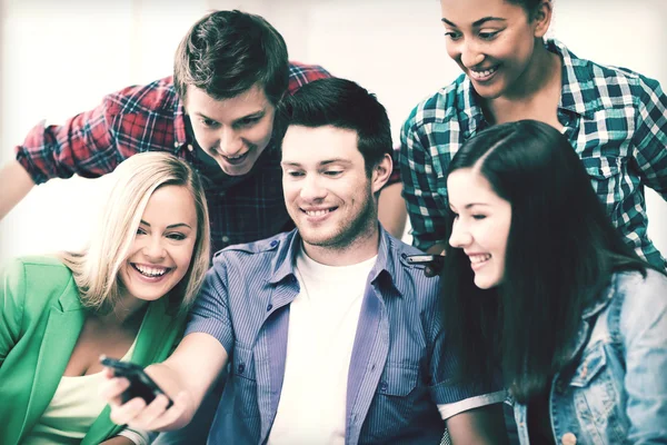 Schüler schauen in der Schule aufs Smartphone — Stockfoto